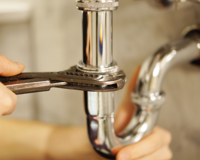 Plumber fixing pipes